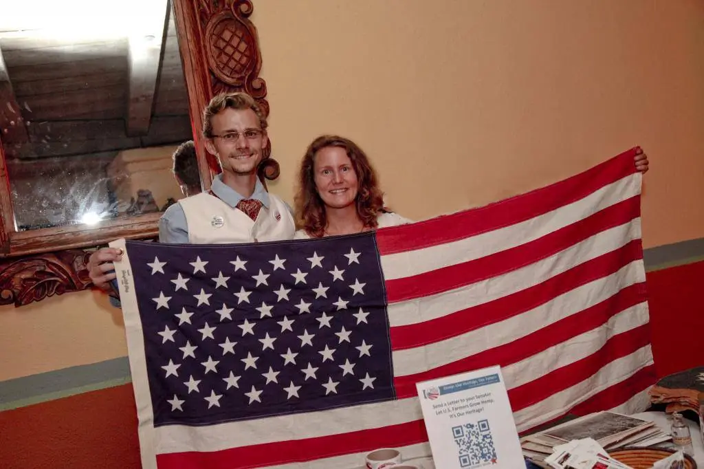 The owners of Bulk Hemp Warehouse holding an American flag